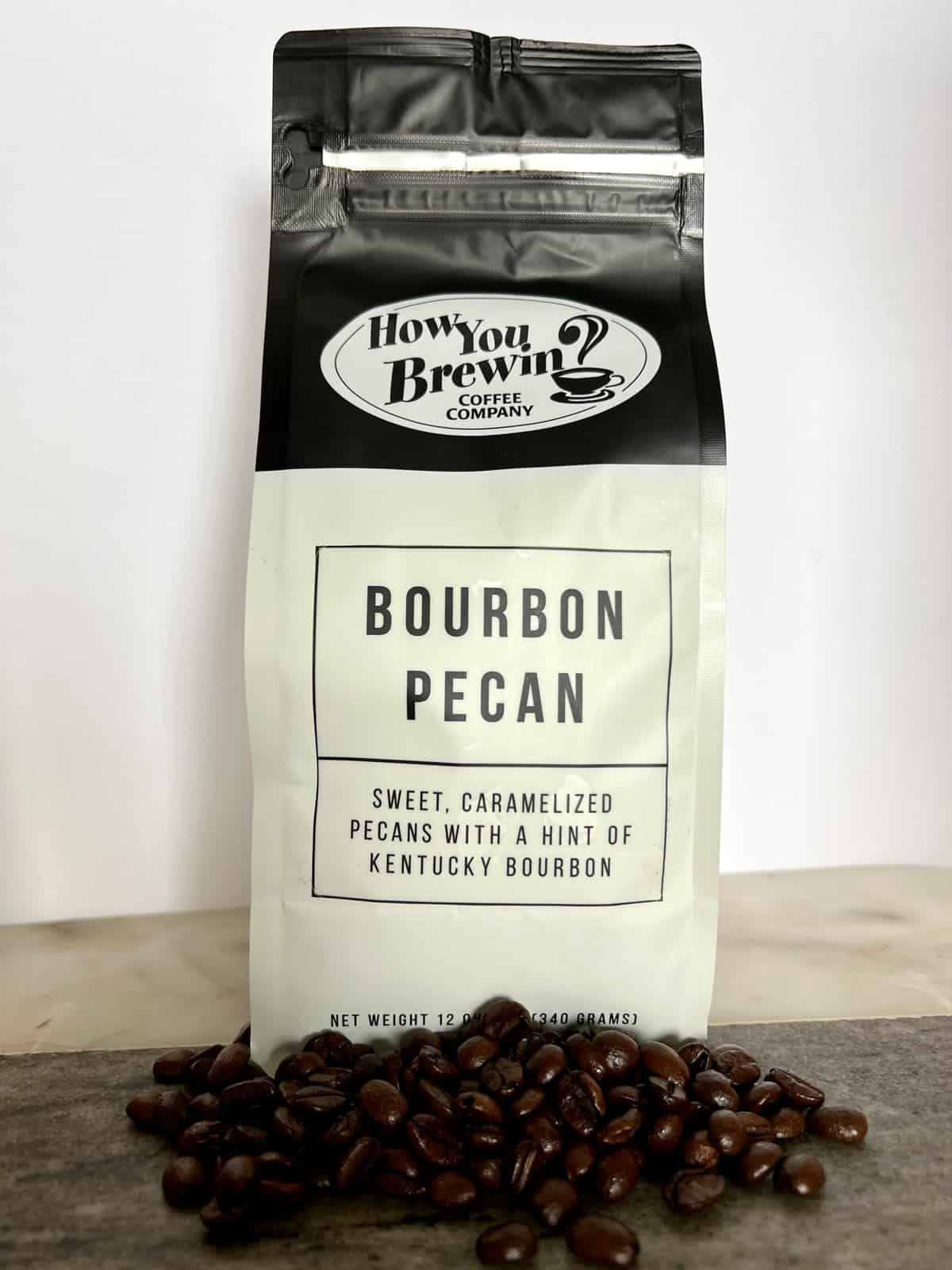 Bourbon-Pecan-coffee-packaging-stands-on-coffee-beans-scaled