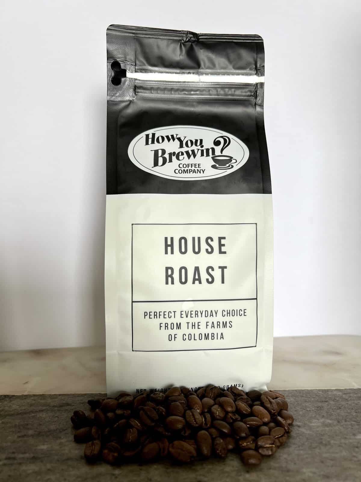 House-Roast-coffee-packaging-stands-on-coffee-beans-scaled