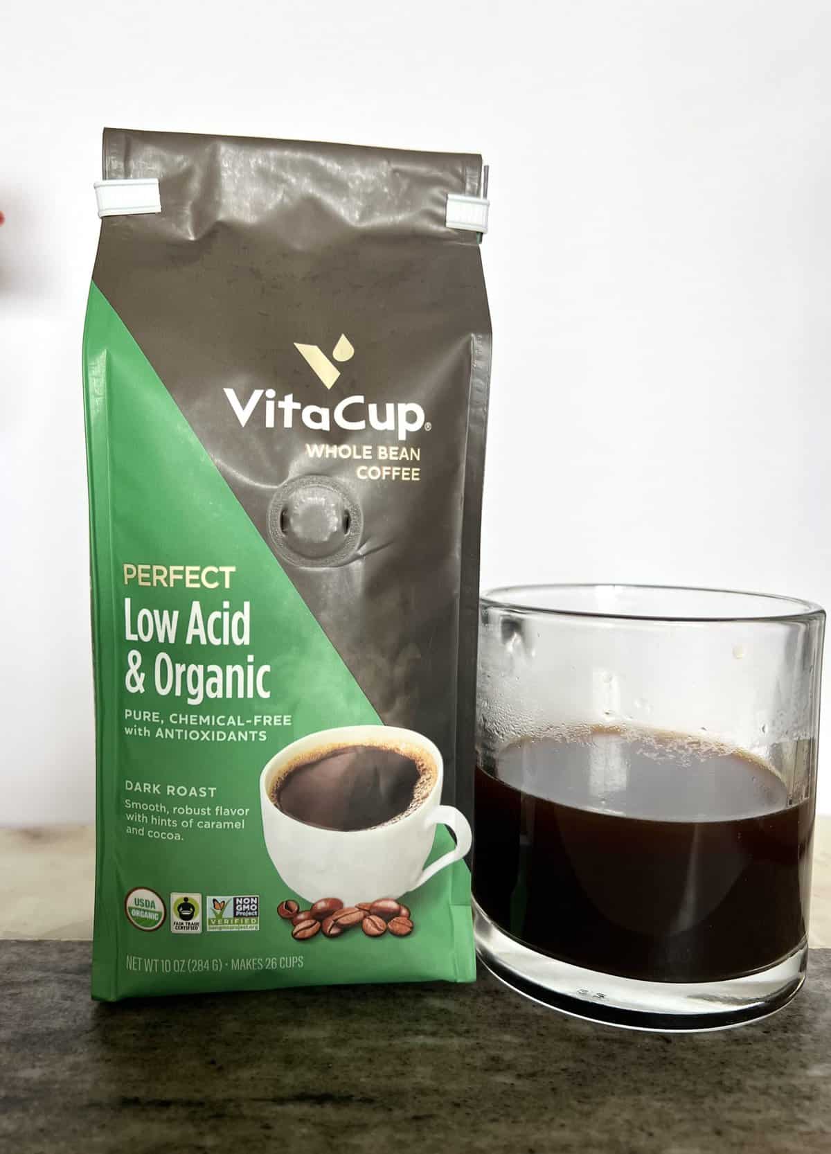VitaCup-Perfect-Low-Acid-Coffee-Beans-Coffee-stands-next-to-a-brewed-cup-of-coffee-scaled